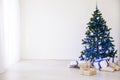 Christmas tree with blue in a white room with toys for Christmas Royalty Free Stock Photo