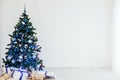 Christmas tree with blue in a white room with toys for Christmas Royalty Free Stock Photo