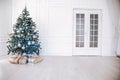 Christmas tree with blue in a white room with toys for Christmas Royalty Free Stock Photo
