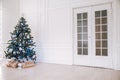 Christmas tree with blue in a white room with toys for Christmas Royalty Free Stock Photo