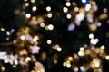 Christmas tree bokeh light in green yellow golden color, holiday abstract background, blur defocused with grain hipster color. Royalty Free Stock Photo