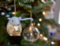 Christmas tree branch adorned with a cute  mouse ornament and white string lights Royalty Free Stock Photo