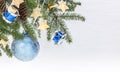 Christmas tree branch with blue glass ball, decorative drums toys and star light garlands on white background Royalty Free Stock Photo