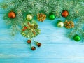 Christmas tree branch on a blue wooden decorative background, snow, frame, pine cone Royalty Free Stock Photo