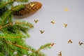 Christmas tree branch close-up with cones, small golden deer on white background. Copy space. Christmas postcard, mockup, design, Royalty Free Stock Photo