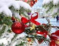 Christmas tree branch deciration red ball and bow illumination on festive winter street in Tallinn old town scene Royalty Free Stock Photo
