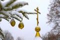 Christmas tree branch with decorations on the background of the Orthodox cross with a crucifix. The Orthodox Church. Winter is Chr