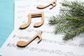 Christmas tree branch, notes and music sheets on table Royalty Free Stock Photo