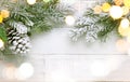 Christmas tree branch and pine cone in snow on a white wooden background. Winter festive concept. Flat lay, copy space Royalty Free Stock Photo