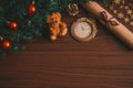 Christmas tree branch with red balls, a letter with a ribbon, a bear toy, a cone on the table flat lay top view copy space