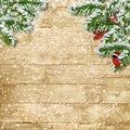 Christmas tree branch with snowfall on the wooden board