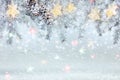 Christmas tree branch under snow decorated with glowing star lights garland Royalty Free Stock Photo