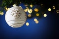 Christmas tree branch with white bauble