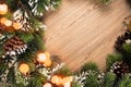 Christmas tree branch wreath with blue and green baubles and golden defocused lights on wooden background