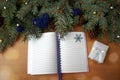 Christmas tree branches, cones, hearts, stars, a notebook on a wooden texture