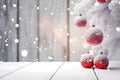 Christmas tree branches covered with snow and hanging red balls. Royalty Free Stock Photo