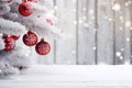 Christmas tree branches covered with snow and hanging red Christmas balls. Royalty Free Stock Photo