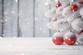 Christmas tree branches covered with snow and hanging red Christmas balls. Royalty Free Stock Photo