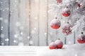 Christmas tree branches covered with snow and hanging red ornamented balls. Royalty Free Stock Photo