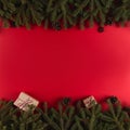 Christmas tree branches in the form of a frame on a red background, Christmas concept, greeting card copy space Royalty Free Stock Photo