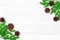 Christmas tree branches with pine cones on white wood table. Copy space. Christmas frame background Royalty Free Stock Photo