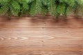 Christmas tree branches on wooden background.