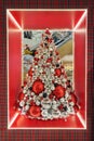 Christmas tree with bright layers in shop. Christmas decoration prepared for sale in supermarket.