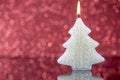 Christmas tree candle light with reflection on red blurred bokeh Royalty Free Stock Photo