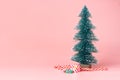 Christmas tree with candy cane on pastel pink studio background. Royalty Free Stock Photo