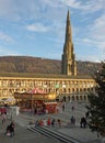 A christmas tree and carousel in the public square at Halifax piece hall west yorkshire