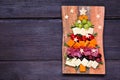 Christmas tree charcuterie board over a dark wood background Royalty Free Stock Photo