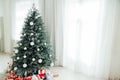 Christmas tree Christmas decoration interior of the white room with postcard gifts