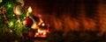 Christmas tree close up on blurred burning fireplace background