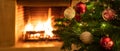 Christmas tree close up on burning fireplace background Royalty Free Stock Photo