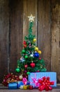 Christmas tree with colorful ornaments a wood background Royalty Free Stock Photo