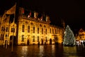 A Christmas tree and colourful lights in Brugge` city centre. A night landscape of Brugge, Belgium.