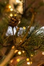 Christmas tree with cones on a city street illuminated with a garland and advertising lights Royalty Free Stock Photo