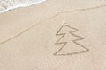 Christmas tree contour with star and wave on the beach