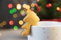 Christmas tree cookie on cup of cappuccino.