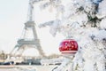 Eiffel tower and Christmas tree covered with snow in Paris