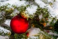 Christmas tree covered with snow. Xmas tree toys, balls and garland. Close-up Royalty Free Stock Photo