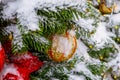 Christmas tree covered with snow. Xmas tree toys, balls and garland. Close-up Royalty Free Stock Photo