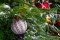 Christmas tree covered with snow. Xmas tree toys, balls and garland. Close-up Royalty Free Stock Photo