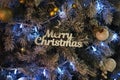 Christmas tree and decor with wooden words blue lights and color balls Royalty Free Stock Photo