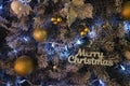 Christmas tree and decor with wooden words blue lights and color balls Royalty Free Stock Photo
