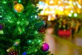 Christmas tree decorated with balls and a baubles during the New Years celebration. City street with night lantern lights Royalty Free Stock Photo