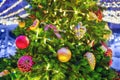 Christmas tree decorated with balls, garlands and bauble on the street during the New Years celebration