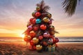 Christmas tree decorated with balls on a sandy tropical exotic beach at sunset Royalty Free Stock Photo