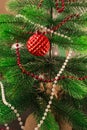 The Christmas tree is decorated with beads and one red glass bead. New Year`s balloon, with uneven surface. Beautiful Royalty Free Stock Photo