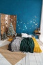 Christmas tree decorated with blue balls and dried oranges. wood in the interior with screen, light floor and blue wall Royalty Free Stock Photo